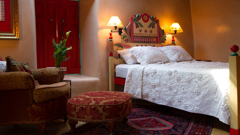 Bedroom with adobe walls and rustic furniture