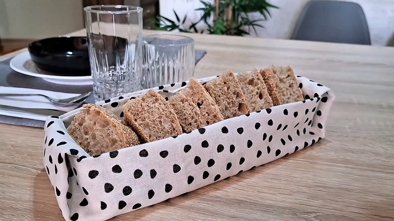 Bread in a fabric bread basket on a dining table