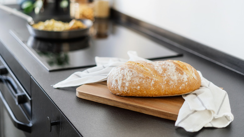 Bread on a kitchen counter with tea towel