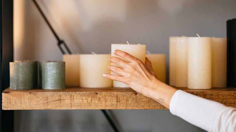 Placing candle on shelf