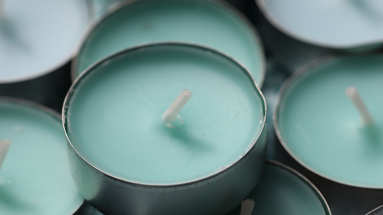 A light green tea light on top of other tea lights.