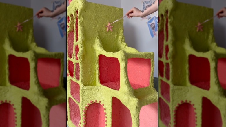 painting a colorful paper clay bookshelf