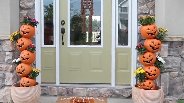 Two pumpkin planter trees on a front porch