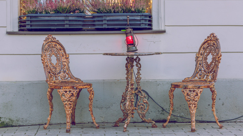 Dated second-hand cast iron patio furniture in need of repainting