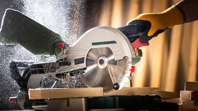 Person cutting wood with a saw