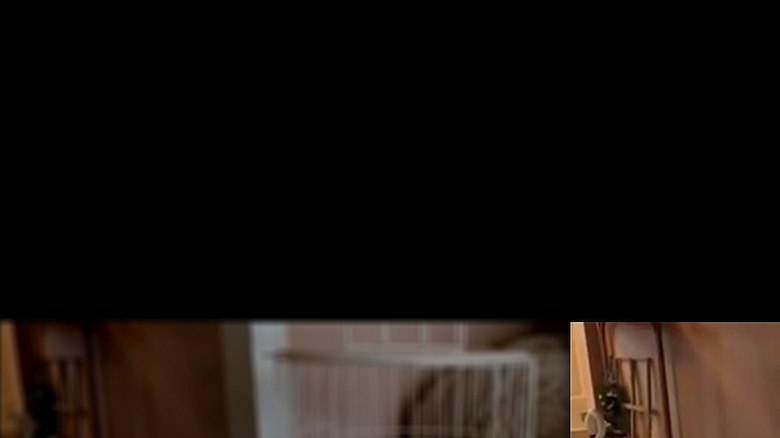 A finished birdcage-inspired farmhouse decor, created from cooling racks from the Dollar Tree, sits on a side table in the living room.