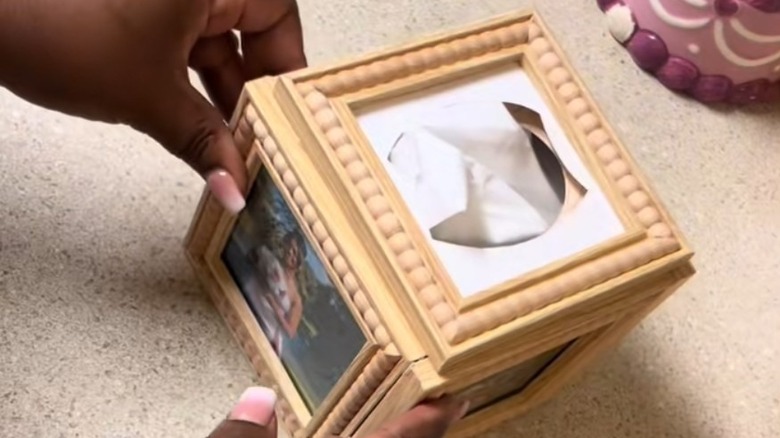 Woman holds DIY frame tissue box cover