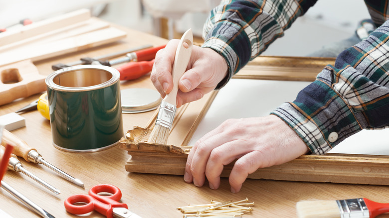 Woman painting a picture frame