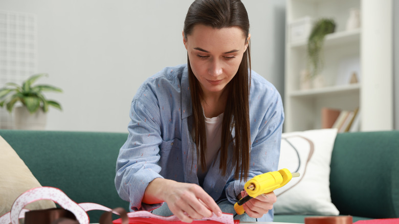 Woman working on project with hot glue gun
