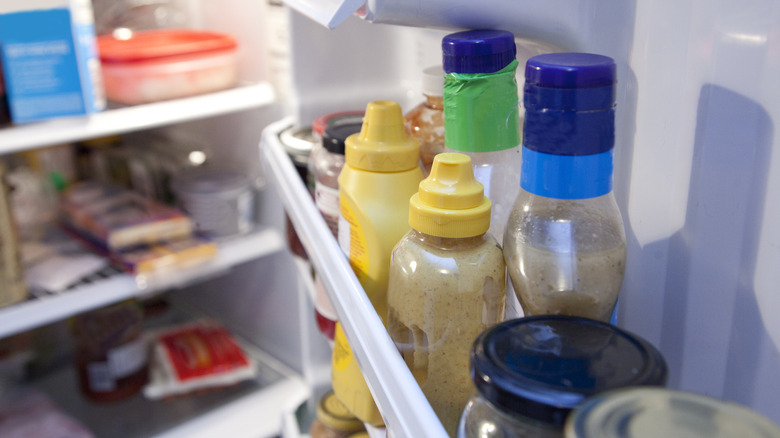 Condiments line a fridge door