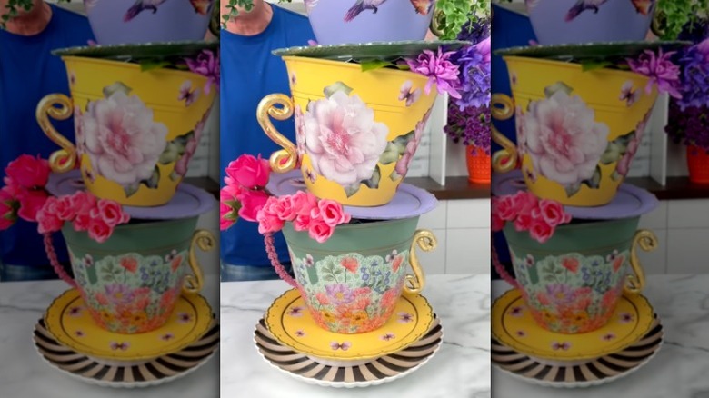 A stack of highly decorated giant teacups made from Dollar Tree plastic planters and trays.