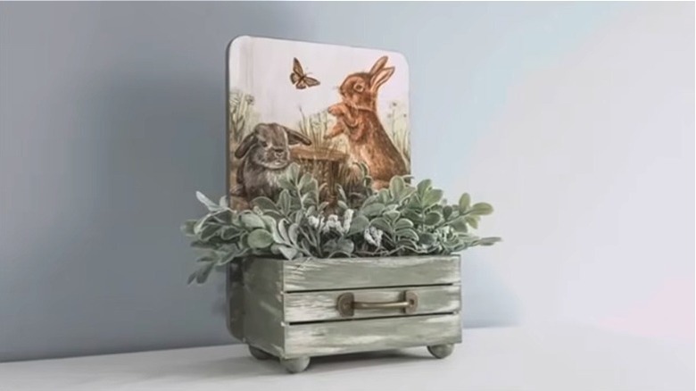 Finished craft project mini planter with greenery and bunny picture panel.