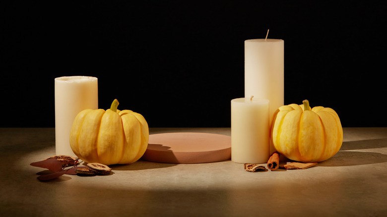 Candles with some mini pumpkins