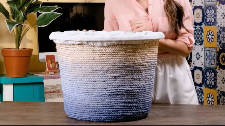 Jute rope blanket storage basket made out of a Dollar Tree laundry hamper.