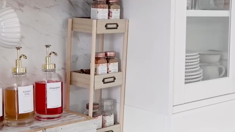 DIY stacked organizer on a kitchen counter holding up spices