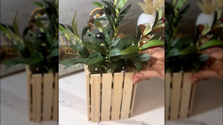 Completed planter made using Dollar Tree mini pallets with a greenery pick inside