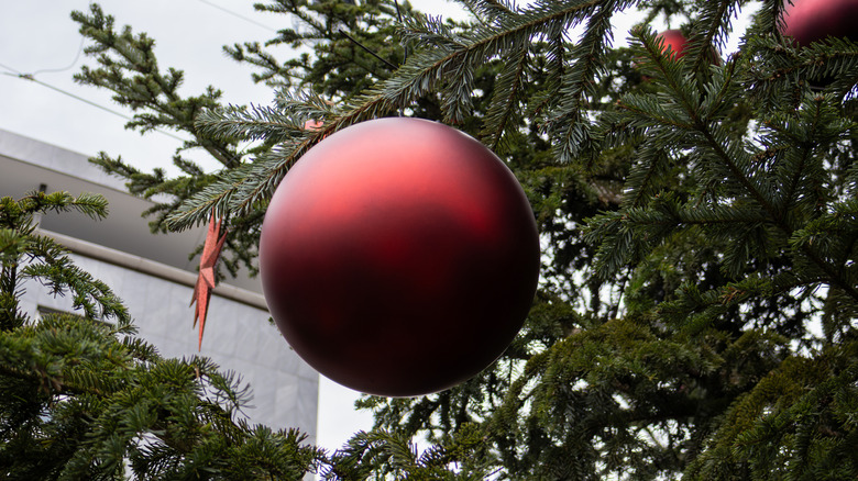 Large red Christmas ball on a tree