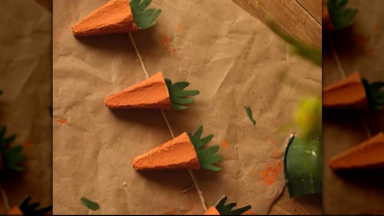 Carrot garland made from egg cartons on a white surface