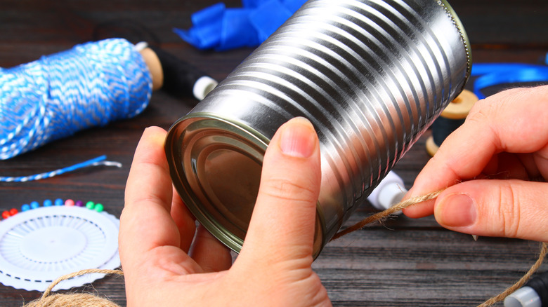 a person crafting with an empty soup can