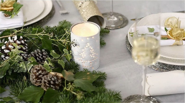 DIY can lantern with Christmas tree design on decorated table