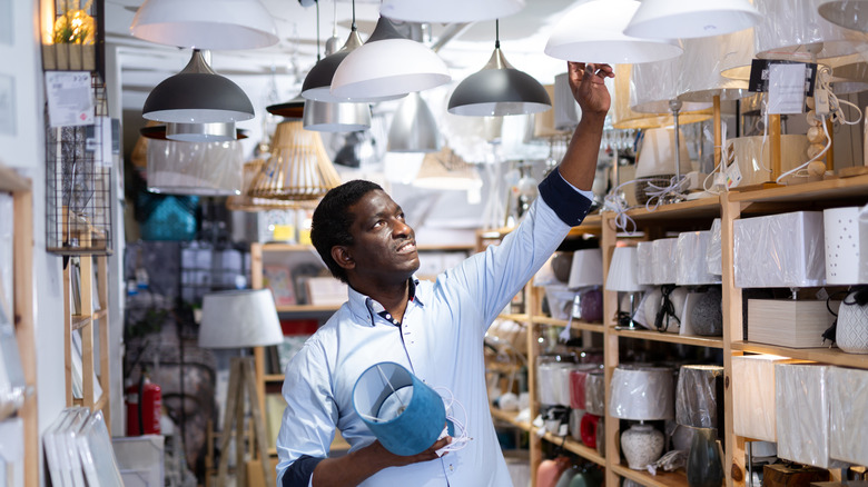 a man shops for pendant lights in a store
