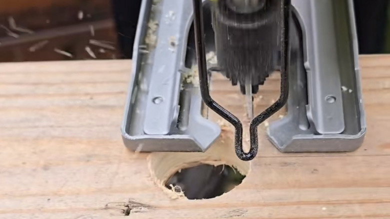 Saw cutting a round notch into wood