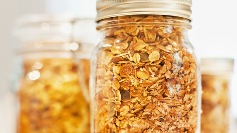Mason jar of granola with others blurred out in the background