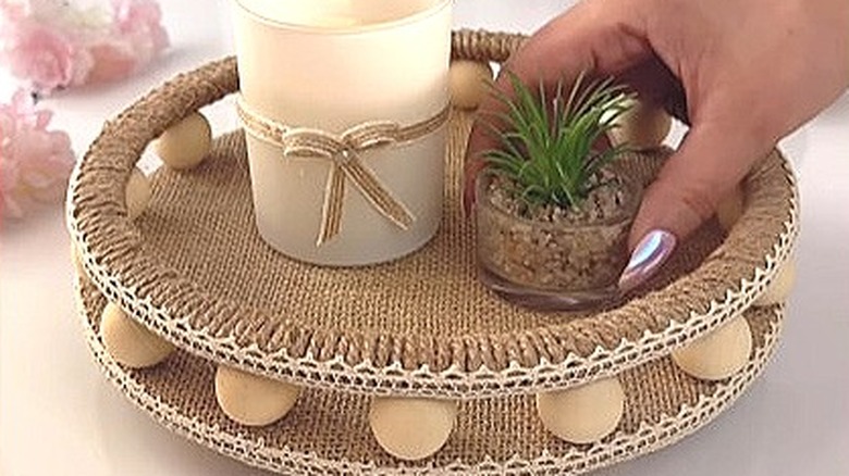 Circular display shelf from cardboard, covered in burlap and twine