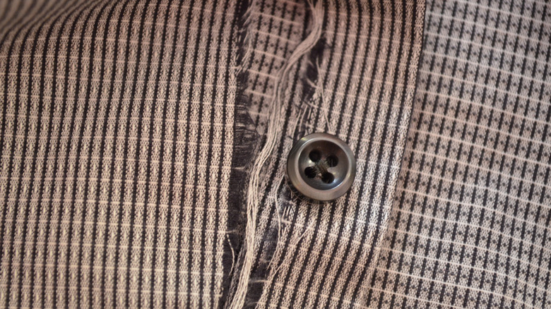 A black and white dress shirt is frayed.