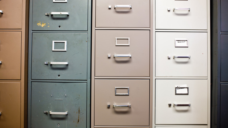 Row of metal filing cabinets in various colors
