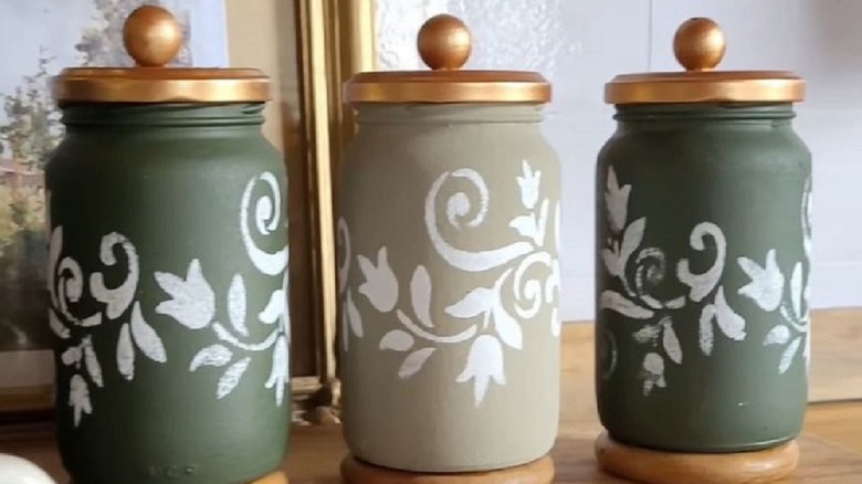 DIY stenciled glass jars to use for decoration and storage