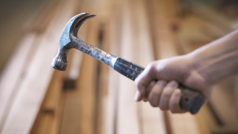 Someone holding a old hammer