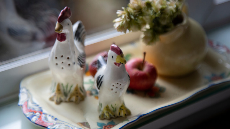 Hen and rooster salt and pepper shakers on a tray