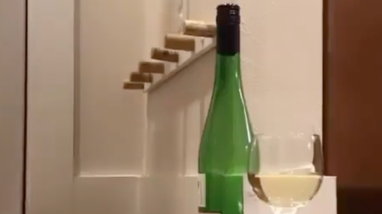 DIY shoe holder next to a bottle and glass of white wine