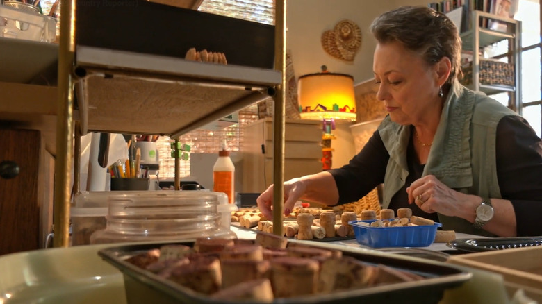 Person working with wine corks to make crafts
