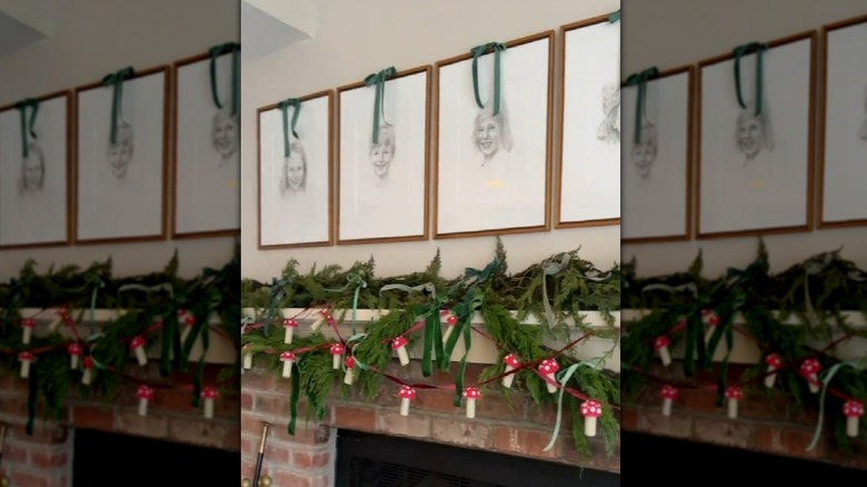 Mushroom garland dangling from greenery on fireplace mantel