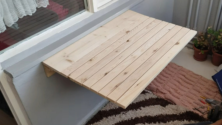 a light wood wall mounted folding table