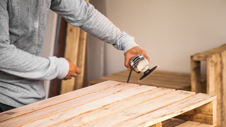 Person working with a wood pallet
