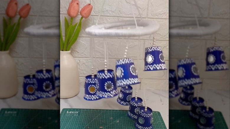 Hanging décor featuring blue cups with silver detailing.