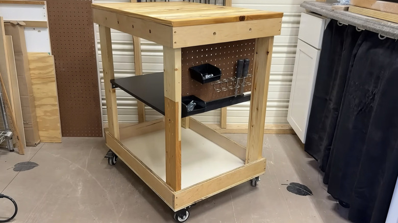 A versatile garage workbench with storage made from scrap wood