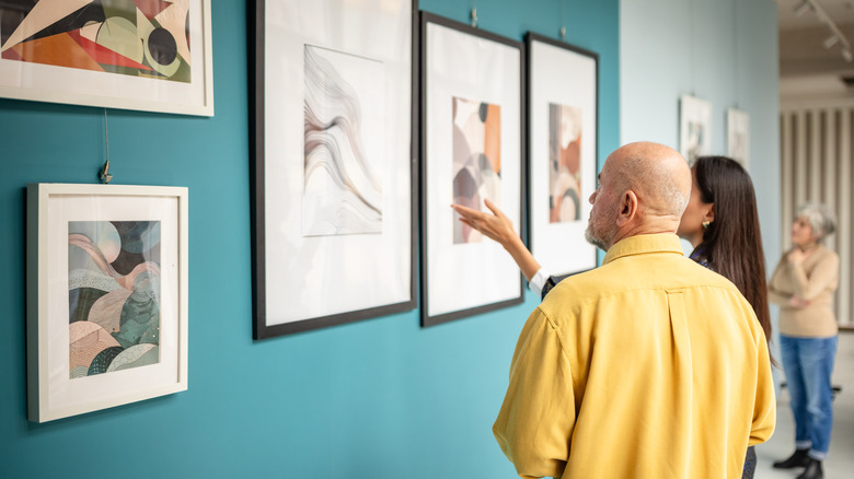People viewing wall art at gallery