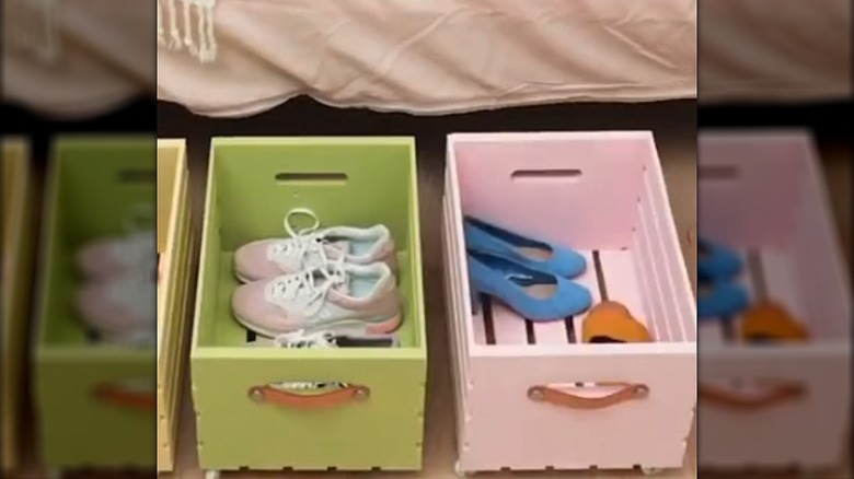 Two colorful wooden crates holding shoes