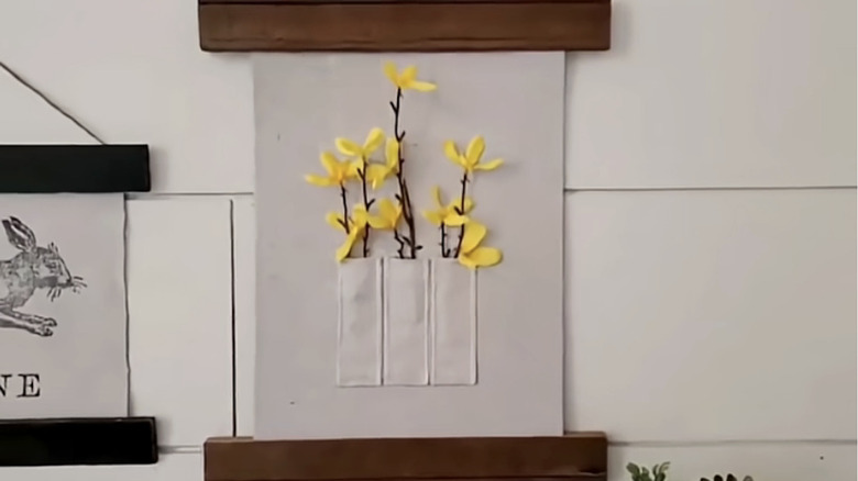 A hanging piece of DIY flower art.