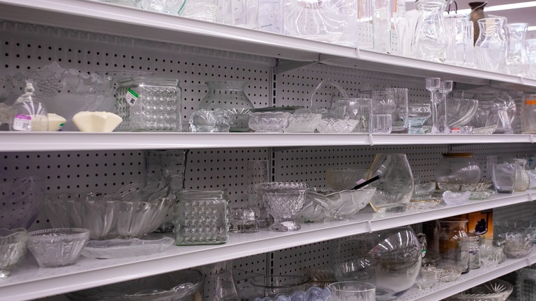 Second hand glassware on thrift store shelves