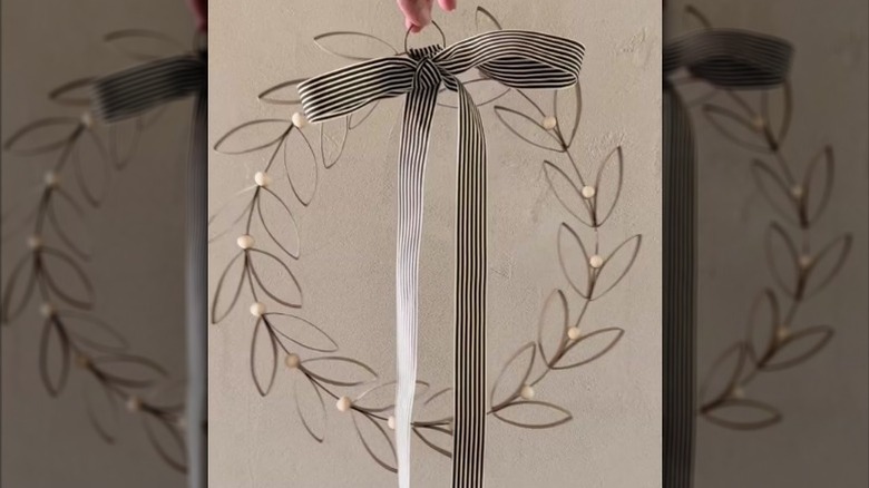 A simple holiday wreath using wire, toilet paper rolls, and a ribbon
