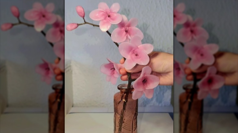 twig and pink candle wax DIY displayed in a vase