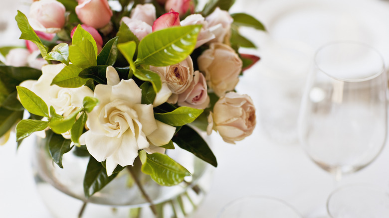 Floral centerpiece next to a wine glass
