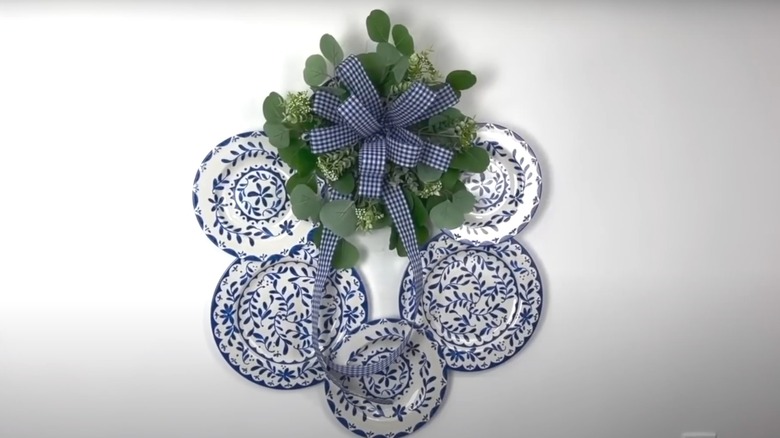 A vintage plate wreath with faux greenery