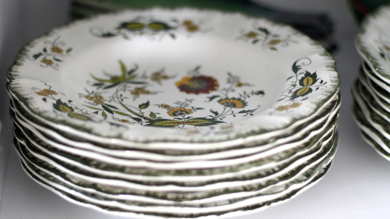 Vintage plates stacked up on a shelf