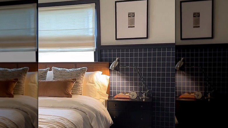 Bedroom with navy-colored grid wallpaper halfway up the wall, with white painted walls on top
